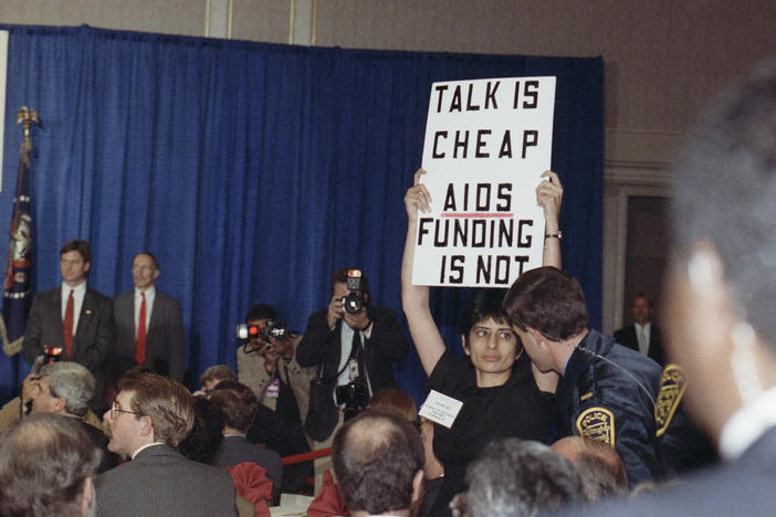 Urvashi Vaid, then-executive director of the National Gay and Lesbian Task Force, protests at then-President George H.W. Bush's address on AIDS in March 1990 in Arlington, Virginia. The pioneering LGBTQ activist and attorney died last week at age 63.