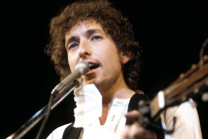 Bob Dylan performing live onstage at a benefit for ousted Chileans.