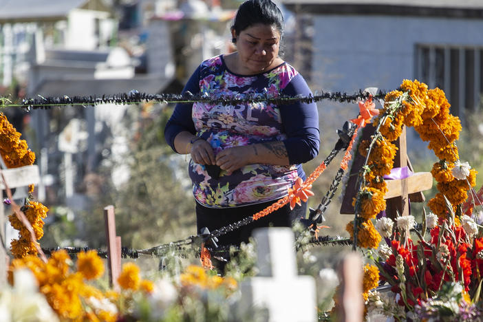 A woman visits a cemetery as part of the 'Day of the Dead' celebration on November 2, 2020 in Valle de Chalco, Mexico.