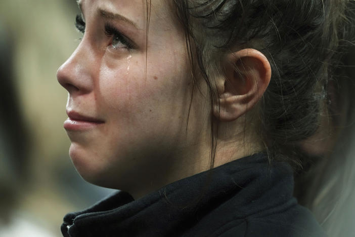 A person attending a vigil for the four University of Idaho students who were killed on Nov. 13, 2022, cries as she listens to family members talk about the victims, Wednesday, Nov. 30, 2022, in Moscow, Idaho.