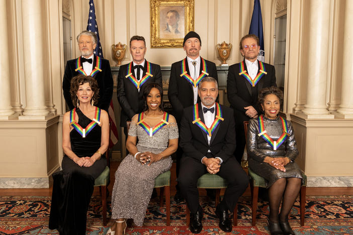 Left to right, back row: U2 members Adam Clayton, Larry Mullen Jr., The Edge and Bono. Front row: Amy Grant, Gladys Knight, George Clooney and Tania León.