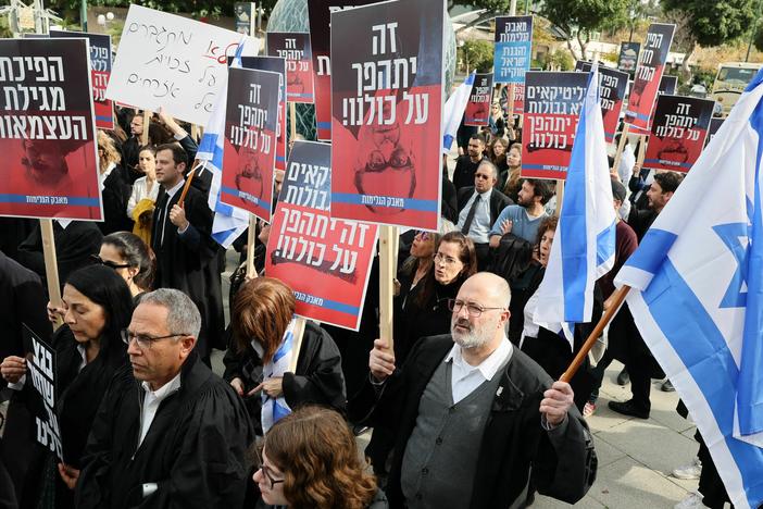 Lawyers gather in a demonstration against the Israeli government's controversial plans to overhaul the judicial system, outside the Tel Aviv District Court of Justice on Jan. 12. The new justice minister Yariv Levin outlined proposals such as allowing politicians to override Supreme Court decisions.