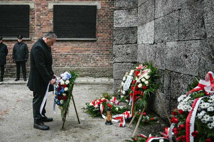 U.S. second gentleman, Doug Emhoff, lays a wreath honoring Holocaust victims at the former Auschwitz site on Friday in Oswiecim, Poland.