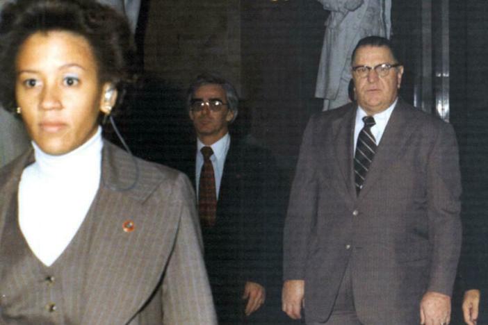 Zandra Flemister, the first Black woman special agent in the Secret Service, left the agency after four years because of discrimination. She is seen here escorting Prime Minister of Jamaica Michael Manley (right) during his 1977 visit to Washington.
