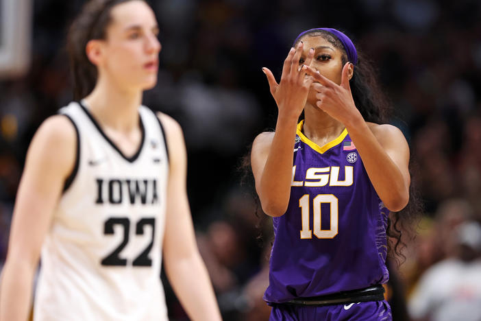 Angel Reese of the LSU Tigers gestures toward Caitlin Clark of the Iowa Hawkeyes toward the end of the NCAA Women's Basketball Tournament championship game in Dallas on Sunday.