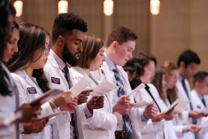 Students at the University of Minnesota celebrate their induction into medical school. The U.S. has disproportionately few Black and Hispanic doctors. Some of the barriers to entering the profession start before even getting into medical school, recent research finds, including financial pressures and racism.