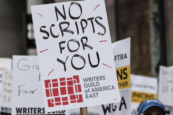 Members of the Writers Guild of America union picket outside Netflix headquarters Wednesday near Union Square in New York.