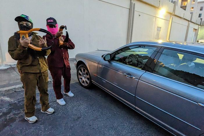 Boot Baby, who wears a black balaclava, and Boot Sheisty, in pink, have built a following of more than 85,000 across Instagram and TikTok through their boot removal business in Atlanta.