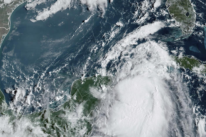 Tropical Storm Idalia moves between Mexico's Yucatan Peninsula, left, and Cuba, right, at 9:40 a.m. ET.