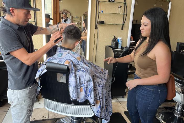 Jennifer Nuno checks her 11-year-old son's back-to-school haircut in the Lincoln Village neighborhood of Milwaukee on August 21.
