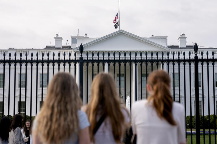 Visitors look upon the White House as the U.S. flag flies at half mast following a school shooting in Nashville, Tenn., last March.