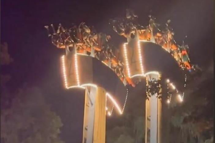 A screenshot taken from social media shows passengers dangling from the area after the abrupt stop of of the Lumberjack ride at Ontario's Wonderland theme park.
