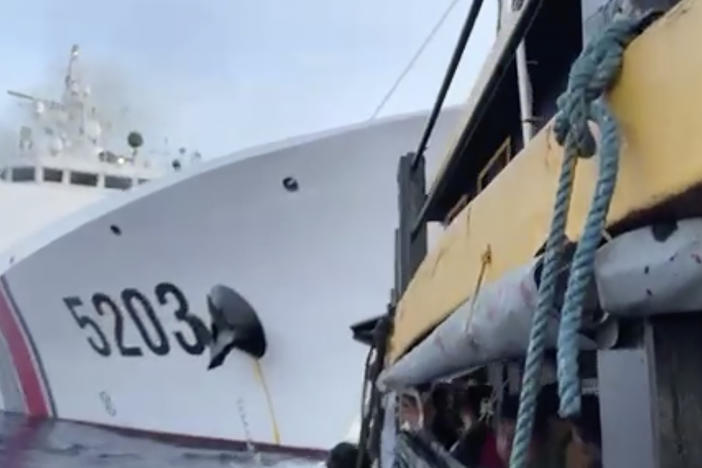 In this image from a video released by the Armed Forces of the Philippines, Filipino sailors, bottom, look after a Chinese coast guard ship with bow number 5203 bumps their supply boat as they approach Second Thomas Shoal, locally called Ayungin Shoal, at the disputed South China Sea on Sunday Oct. 22, 2023.