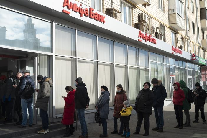 People stand in line to withdraw money from an ATM of Alfa Bank in Moscow last year.