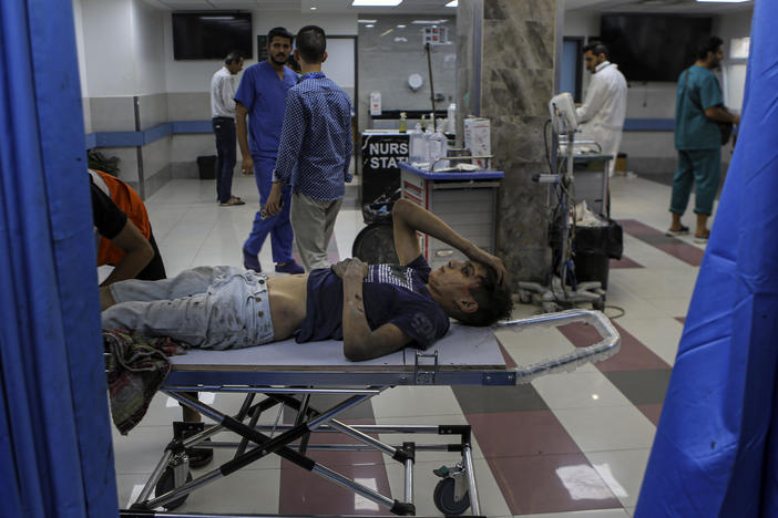 A wounded Palestinian boy arrives to the emergency room of the Al-Shifa hospital, following Israeli airstrikes on Gaza City, central Gaza Strip, on Oct. 17. Israel claims Hamas uses the facility for military purposes and has built a vast underground command center below the hospital. As Israeli forces move in on the facility, hundreds of doctors and patients remain inside.