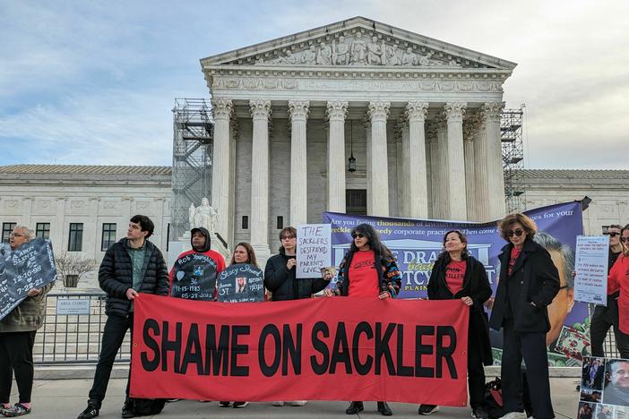 Advocates and victims of the opioid crisis gather outside the U.S. Supreme Court on Dec. 4, 2023, while the justices hear a case about Purdue Pharma's bankruptcy deal. The protesters urged justices to overturn the deal, which would give the Sackler family immunity against future civil cases related to opioids.
