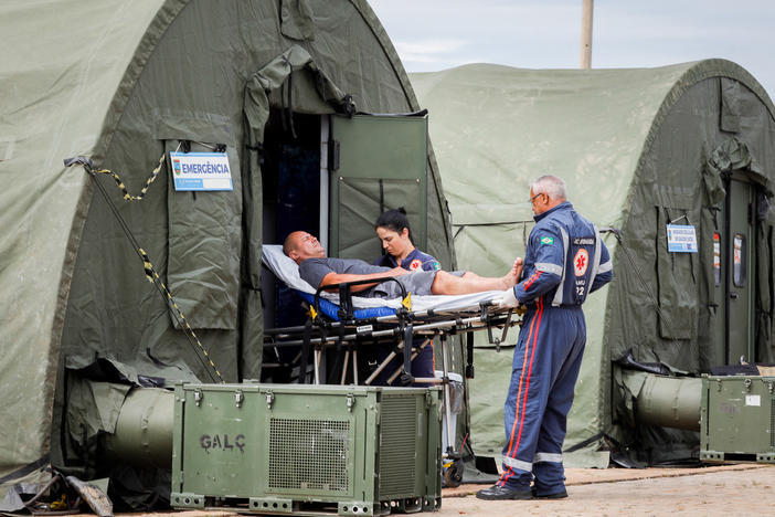 A patient is transferred to a hospital after receiving medical care at an improvised military aid station set up to treat suspected cases of dengue fever in the administrative region of Ceilandia, on the outskirts of Brasilia, on February 6, 2024.