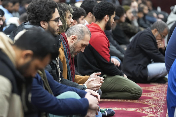 Muslim men listen to Imam Omar Suleiman speak at the Islamic Center of Detroit in Detroit.