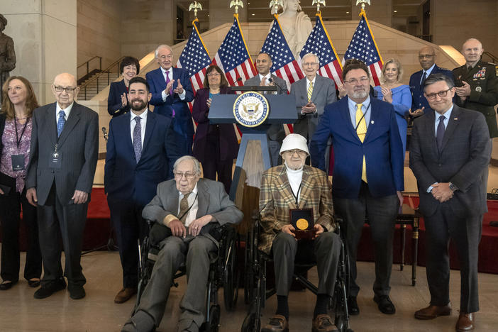 Ghost Army members John Christman, of Leesburg, N.J., second from left standing, Seymour Nussenbaum, of Monroe Township, N.J, in wheelchair at left, and Bernard Bluestein, of Hoffman Estates, Ill., in wheelchair at right, join military and congressional officials as members of their secretive WWII-era unit are presented with the Congressional Gold Medal on Thursday.