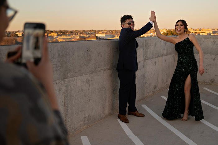 Eddie Almance (left) and his sister Leila pose for their cousin Ailem Villarreal on the rooftop of the Marriott Hotel in downtown Odessa, Texas, before heading to prom. Their grandmother says that for seven generations, the family members have forged close bonds.