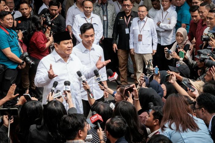Indonesia's President-elect Prabowo Subianto (left) speaks to reporters with Vice President-elect Gibran Rakabuming Raka (second left) as they arrive at the plenary session of the General Elections Commission after his main rivals' challenges to his election victory were rejected in Jakarta, April 24.