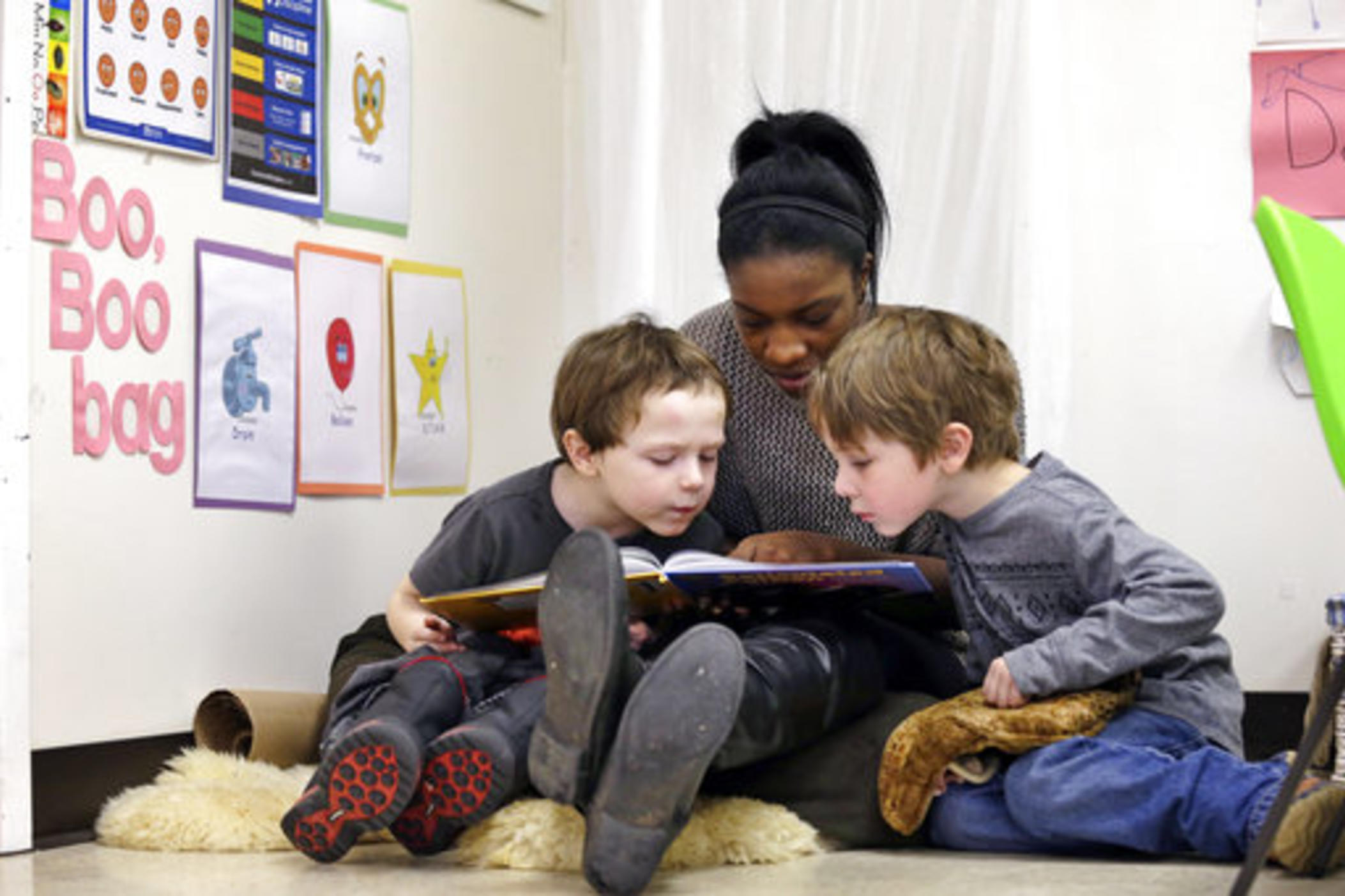 A woman reads to two children