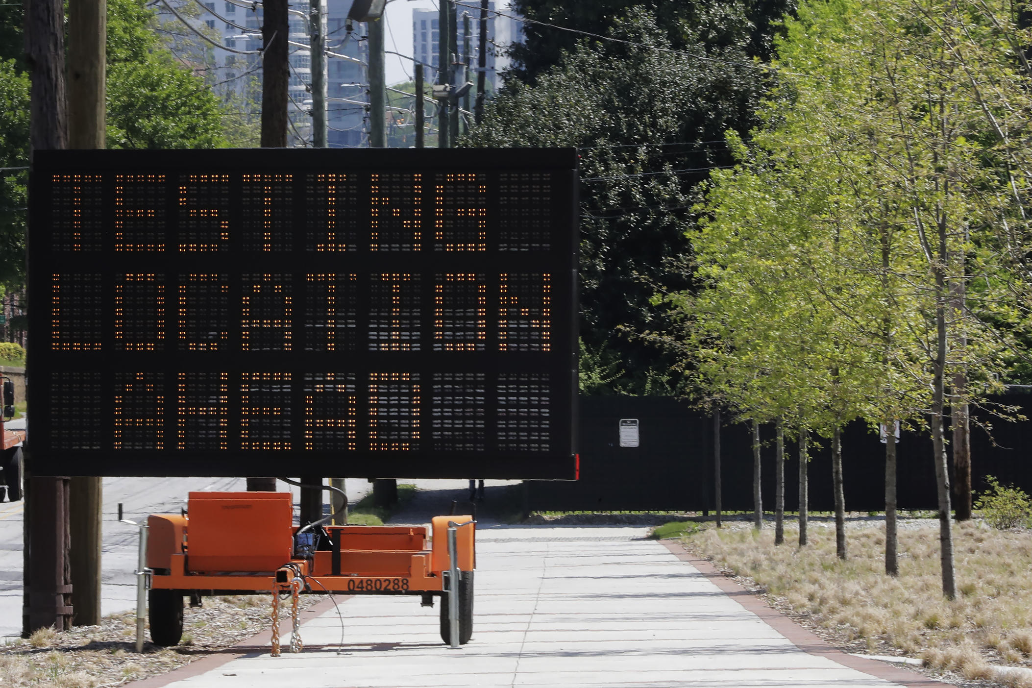 A sign reading "Testing Location Ahead" is seen near the COVID-19 testing area on Georgia Tech's campus, Monday, April 6, 2020, in Atlanta.