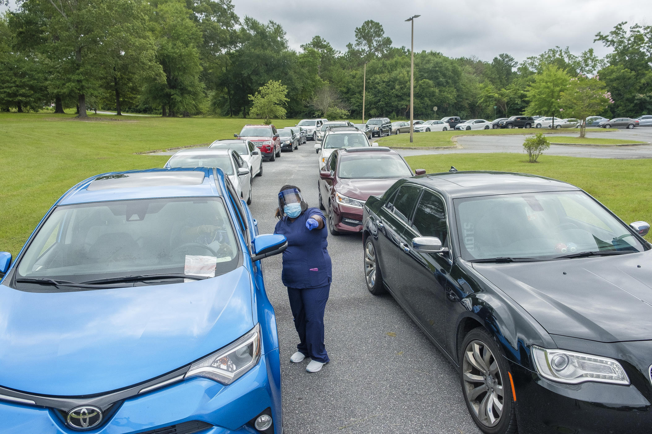 Motorists wait in line for Coronavirus tests at pop up site in Macon