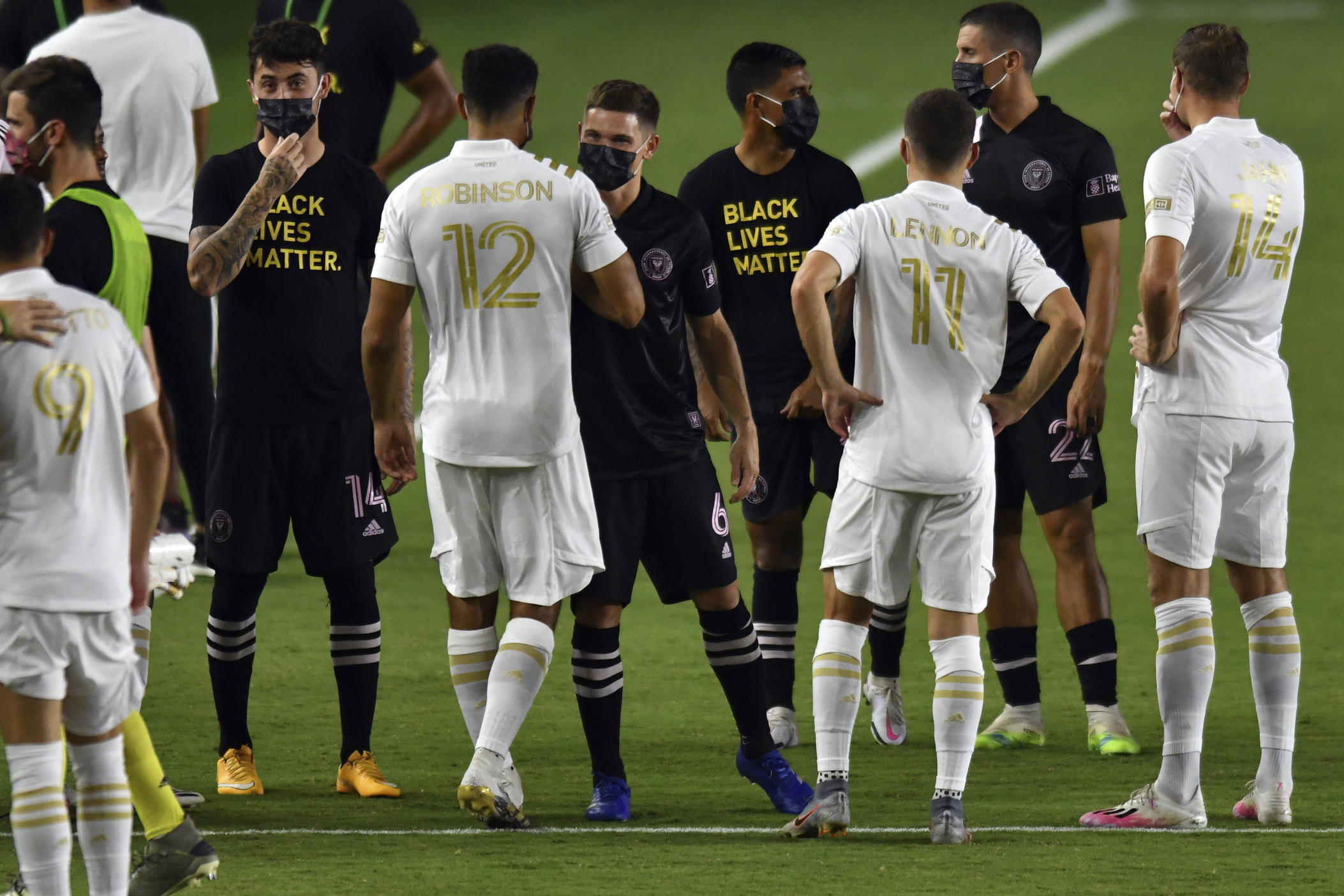 Players from Inter Miami and Atlanta United gather on the field before the postponement of their MLS soccer match Wednesday, Aug. 26, 2020, in Fort Lauderdale, Fla.