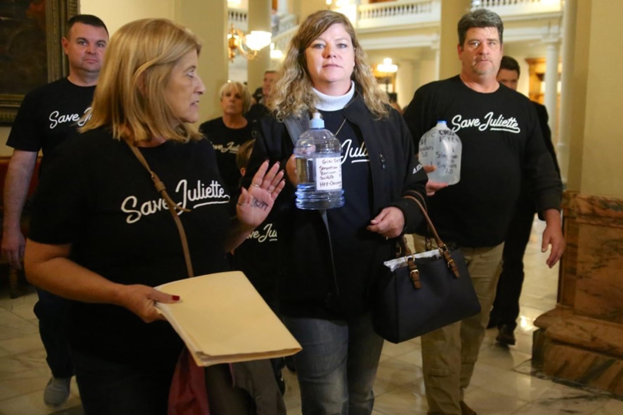 Juliette residents Gini Seitz (center) and Karl Cass (right) have sued Georgia Power for allegedly contaminating the area’s groundwater.