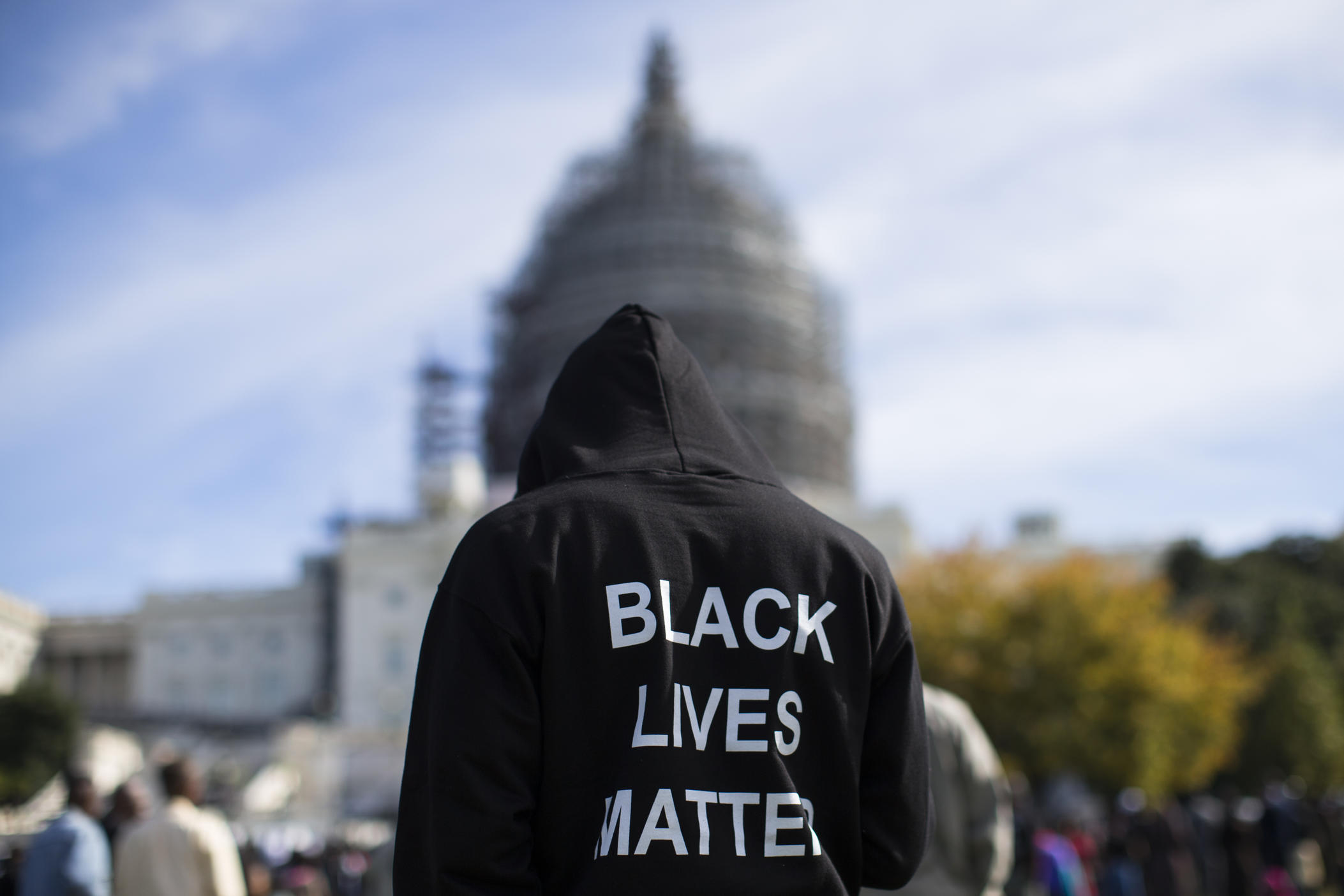 Neal Blair, of Augusta, Ga., wears a hoodie which reads, "Black Lives Matter" as stands on the lawn of the Capitol building during a rally to mark the 20th anniversary of the Million Man March, on Capitol Hill, on Saturday, Oct. 10, 2015, in Washington.