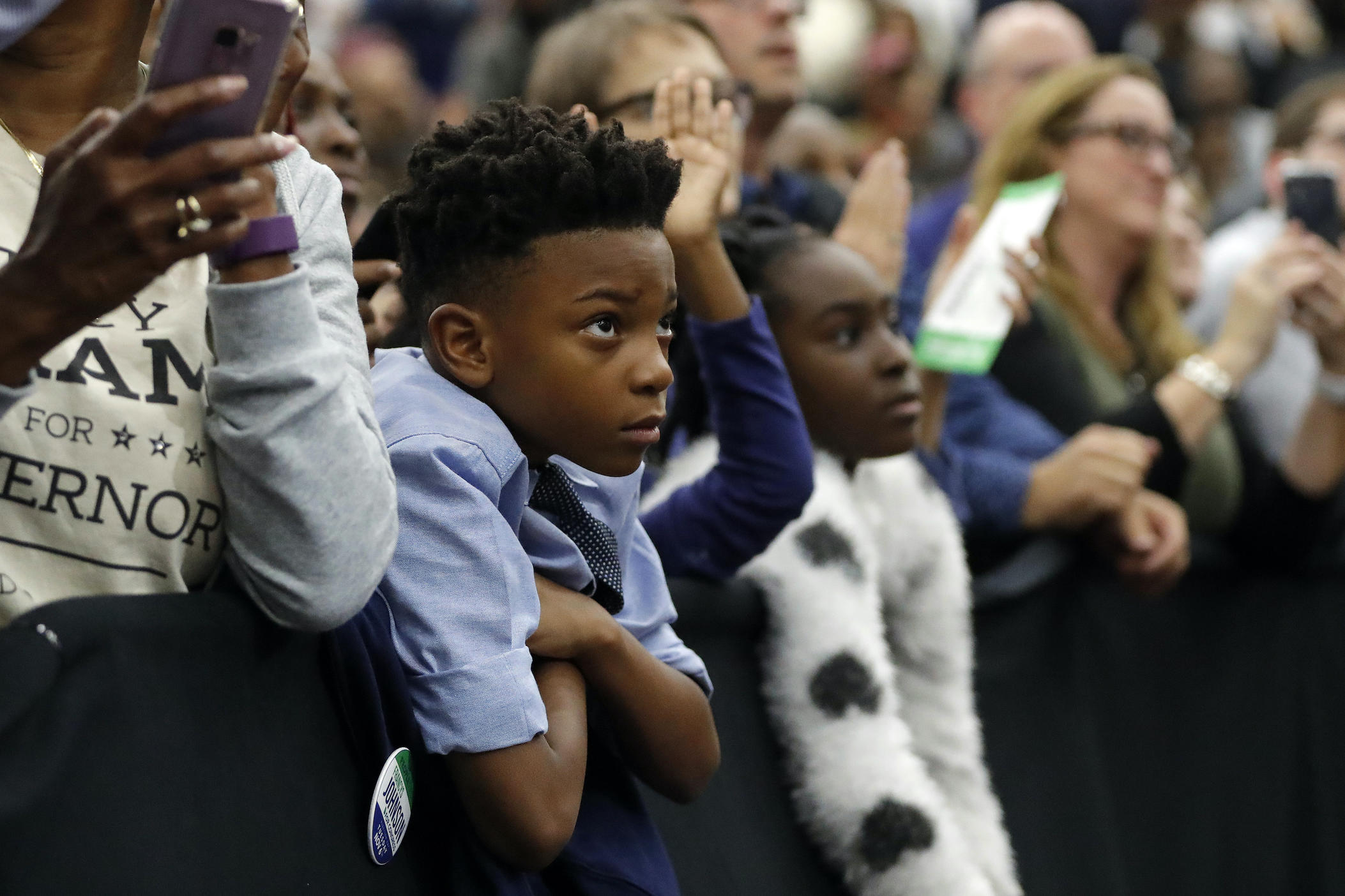 A young child watches as former President Barack Obama steps on stage to speak during a campaign rally for Georgia gubernatorial candidate Stacey Abrams at Morehouse College on Friday, Nov. 2, 2018, in Atlanta. 