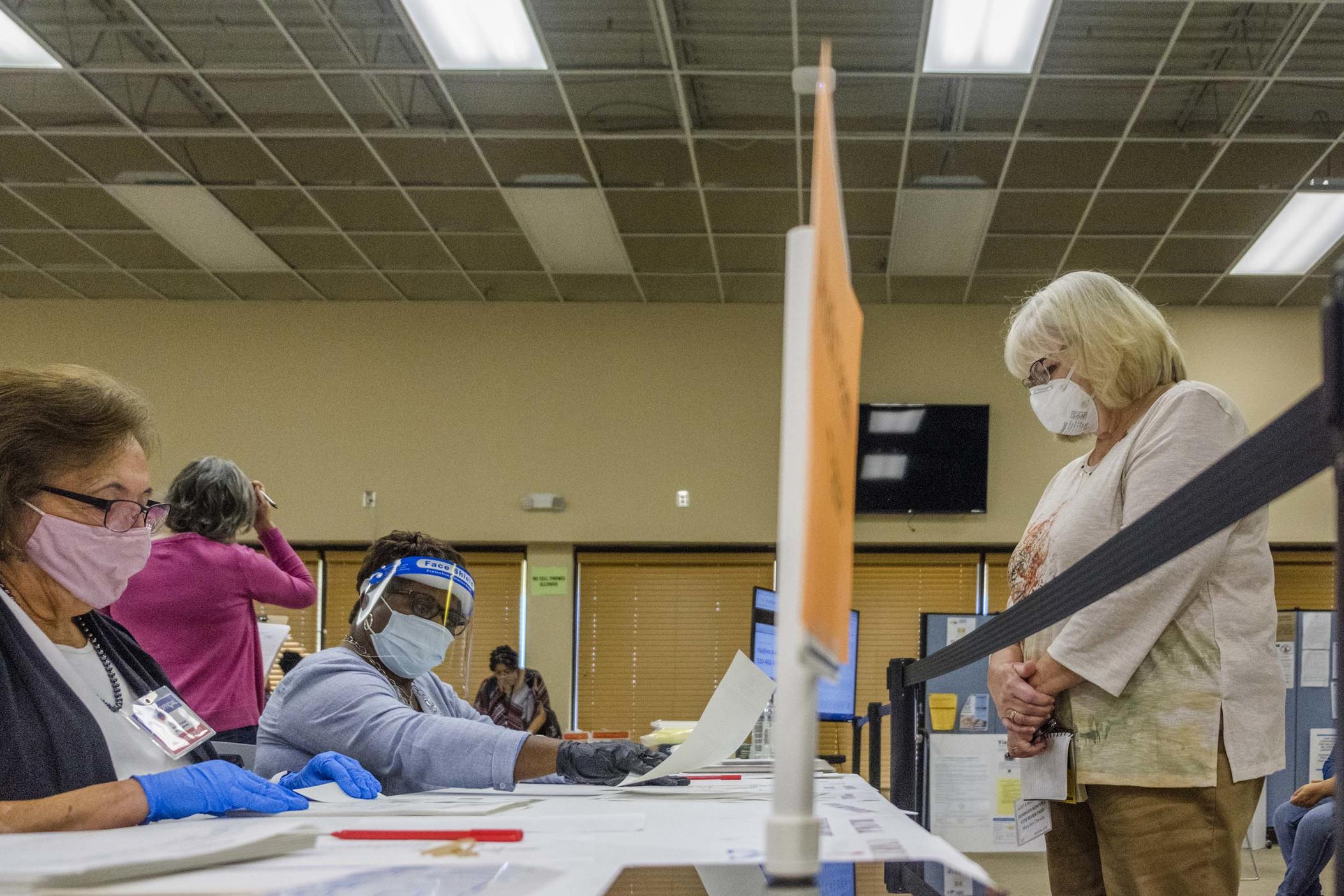 A poll watcher, right, and an auditing team, left, in the Bibb County Board of Elections in Macon on Monday, November 16. Monday was the third day  of the Georgia presidential ballot recount in Bibb County. Auditors began the day a little over halfway through 71,000 ballots. 