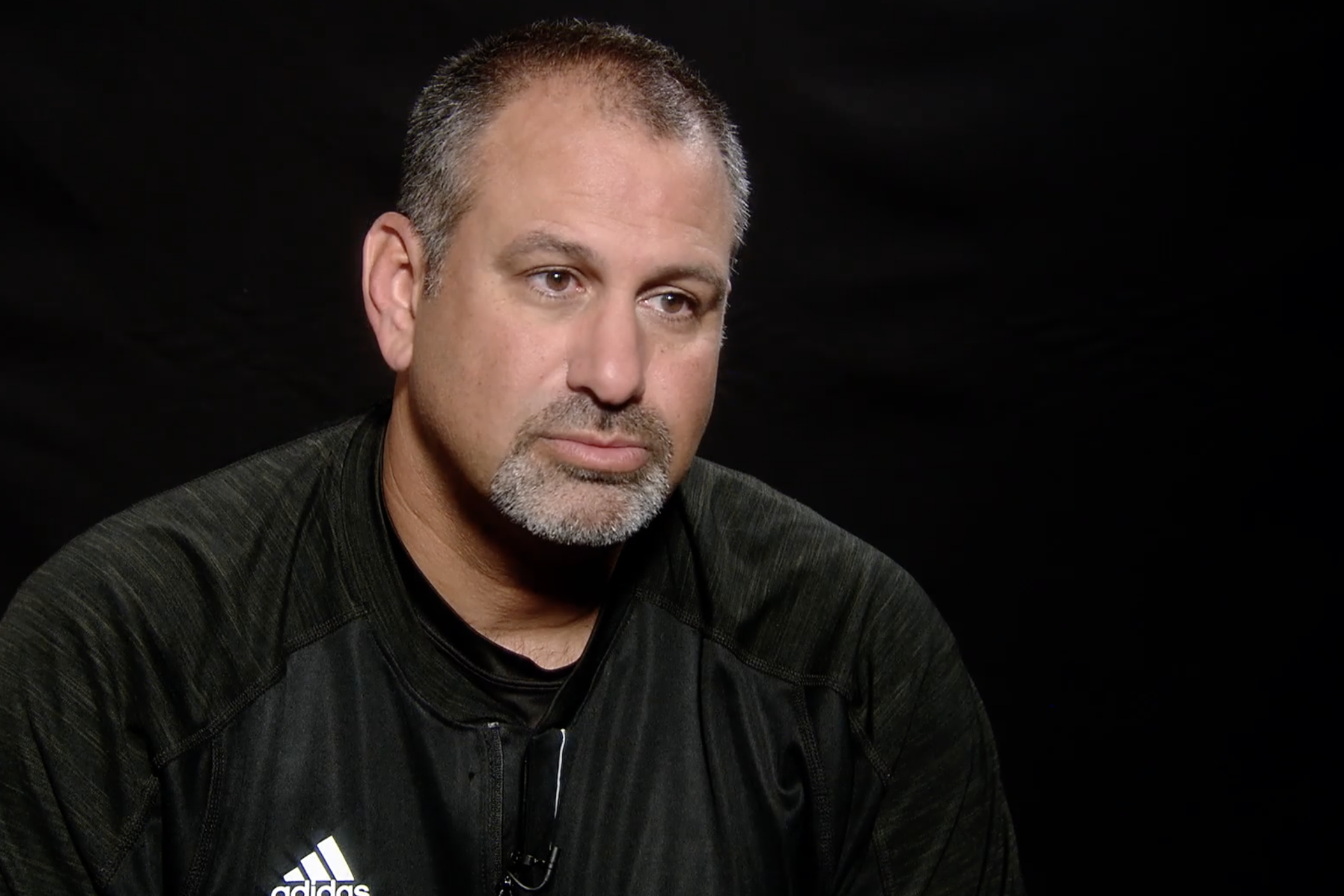 GPB's Jon Nelson (right) talks in 2014 with Dean Fabrizio, the head coach football coach at Lee County High School.