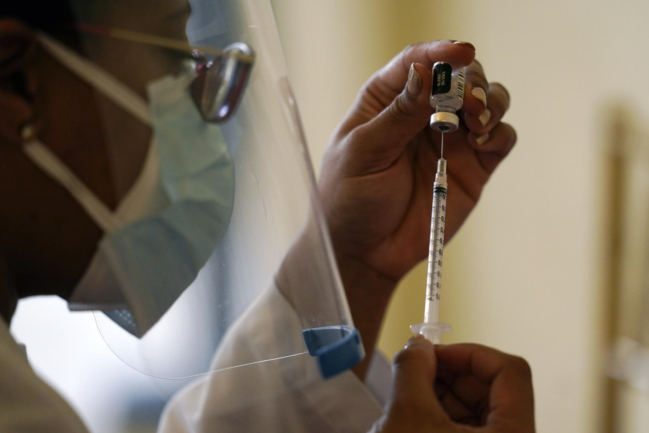 FILE - In this Tuesday, Jan. 12, 2021, file photo, a Walgreens pharmacist prepares a syringe with the Pfizer-BioNTech COVID-19 vaccine for residents and staff at the The Palace assisted living facility in Coral Gables, Fla. Scientists are reporting troubling signs that some recent mutations of the virus that causes COVID-19 may modestly curb the effectiveness of current vaccines but stress that the shots still remain protective. (AP Photo/Lynne Sladky, File)