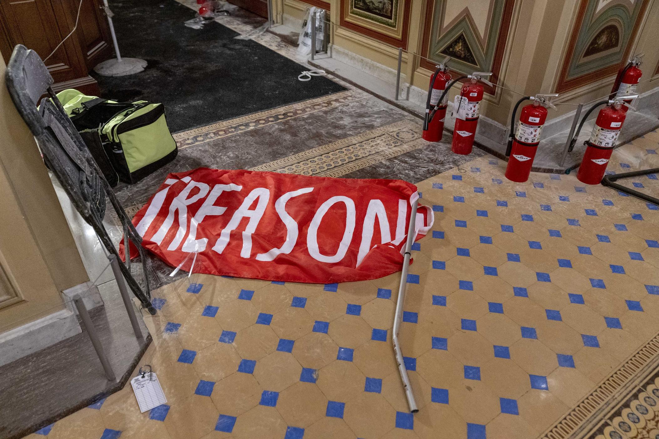 A banner with the word treason lays on the floor after a mob worked its way through the Capitol.