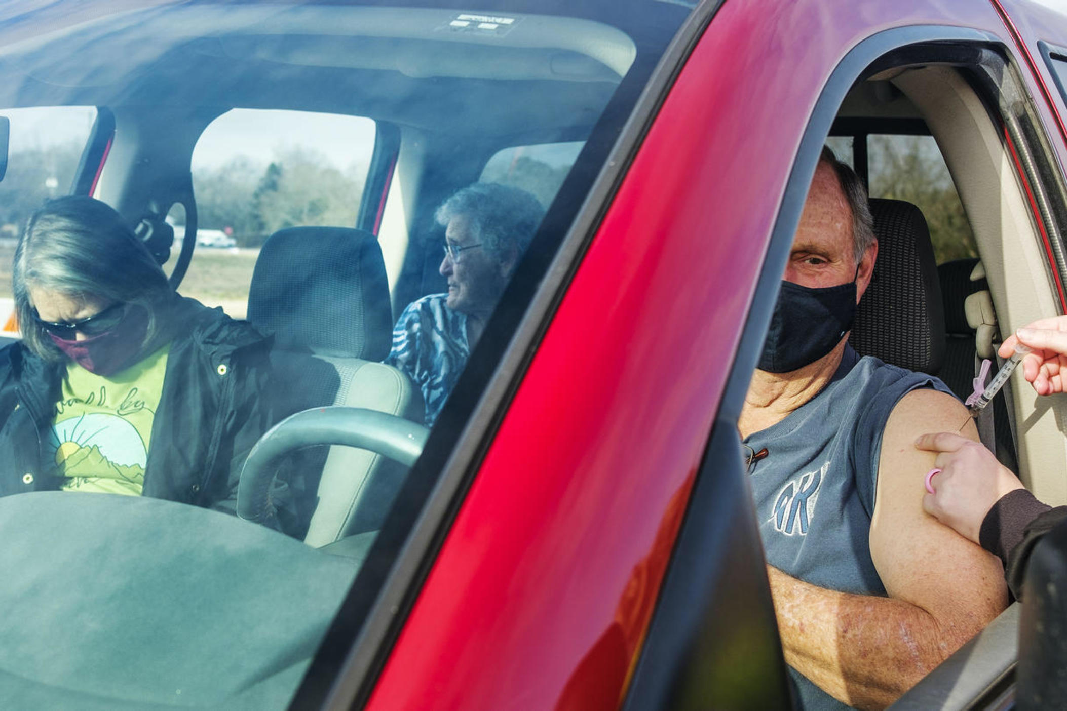 Don Dykes gets vaccinated against COVID-19 in Cochran, Ga., on January 25, 2021. The South Central Health District which includes Cochran was on pace to vaccinate as many as 300 people at the six-hour vaccination event, including Betty Smith, 84, in the back seat. "I felt proud," Smith said when asked how the shot felt.