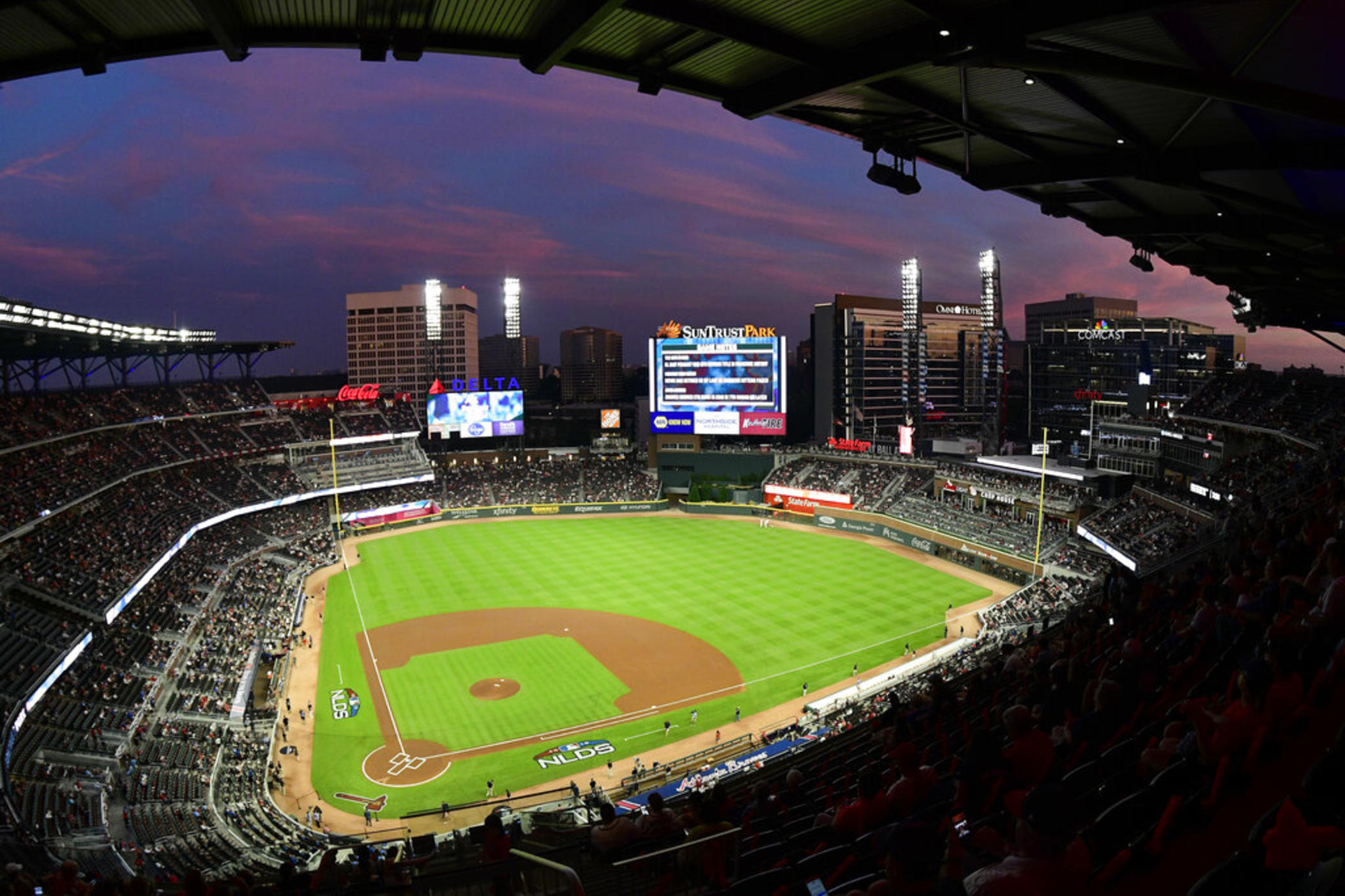  In this Oct. 7, 2018, file photo, ground crews prepare the field at Sun Trust Park, now known as Truist Park, ahead of Game 3 of MLB baseball's National League Division Series between the Atlanta Braves and the Los Angeles Dodgers in Atlanta. Truist Park lost the 2021 All-Star Game on Friday, April 2, 2021, when Major League Baseball decided to move the game elsewhere over the league’s objection to Georgia’s sweeping new election law that critics say restricts voting rights. (AP Photo/John Amis, File)