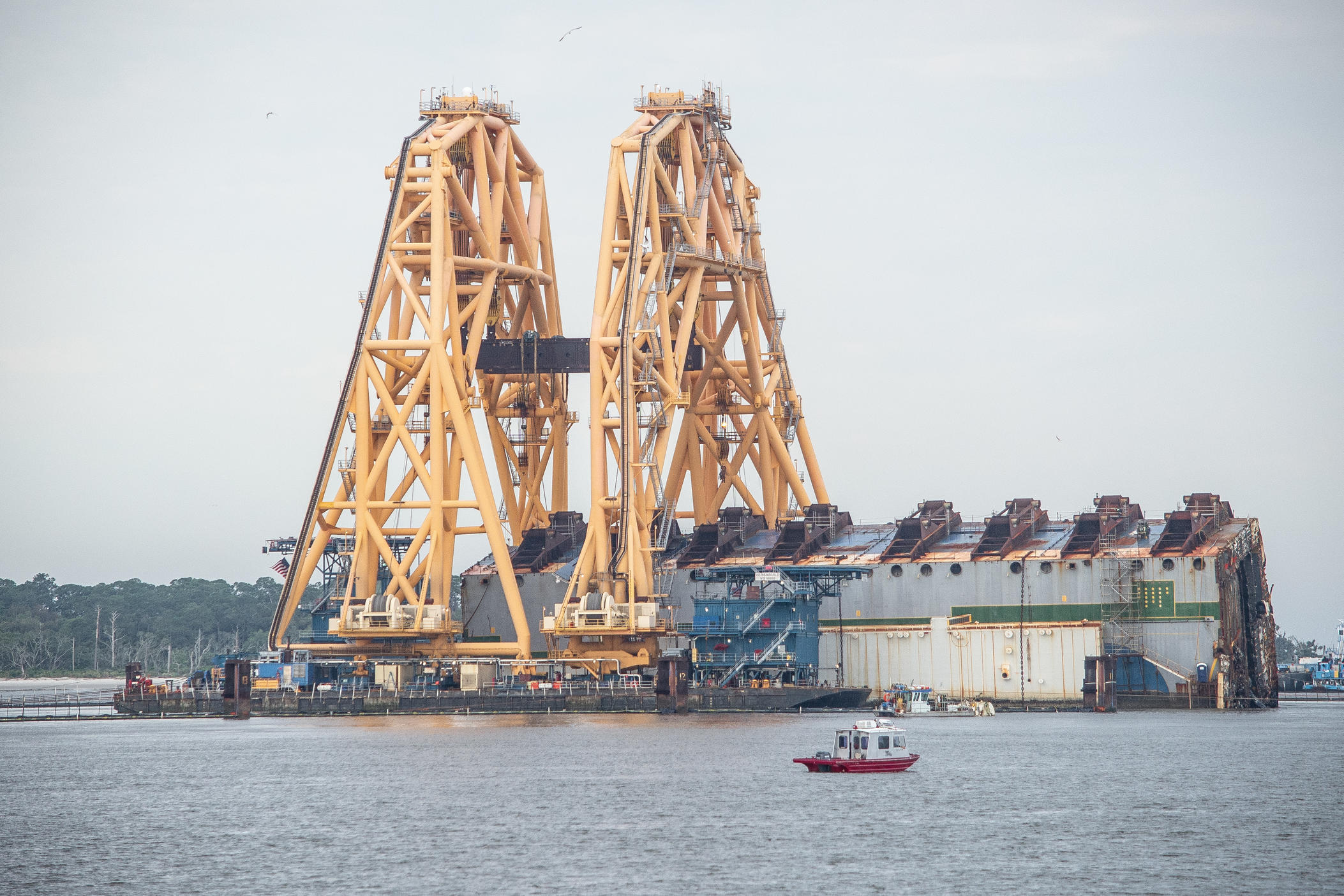 The 255-foot-tall crane vessel VB 10,000 sits astride what remains of the shipwreck of the Golden Ray in the St. Simons Sound in early May. The 656-foot-long car carrier overturned Sept. 8, 2019, while heading out to sea with a cargo of 4,200 vehicles. Four sections have been removed, sheared off by a massive anchor chain muscled up through the shipwreck’s steel exterior and 12 interior decks by the VB 10,000’s powerful system of winches and pulleys. 