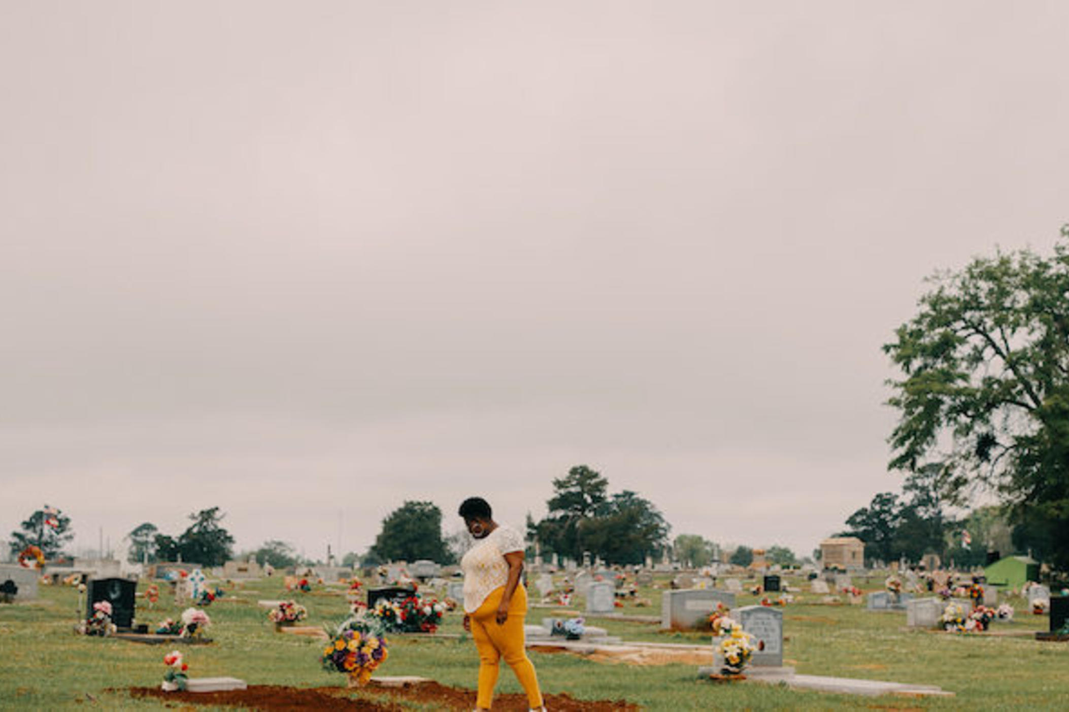 Latasha Taylor visits the cemetery where her mother, uncle, and aunt are buried, in Dawson, Ga. All three died of COVID-19 in 2020.