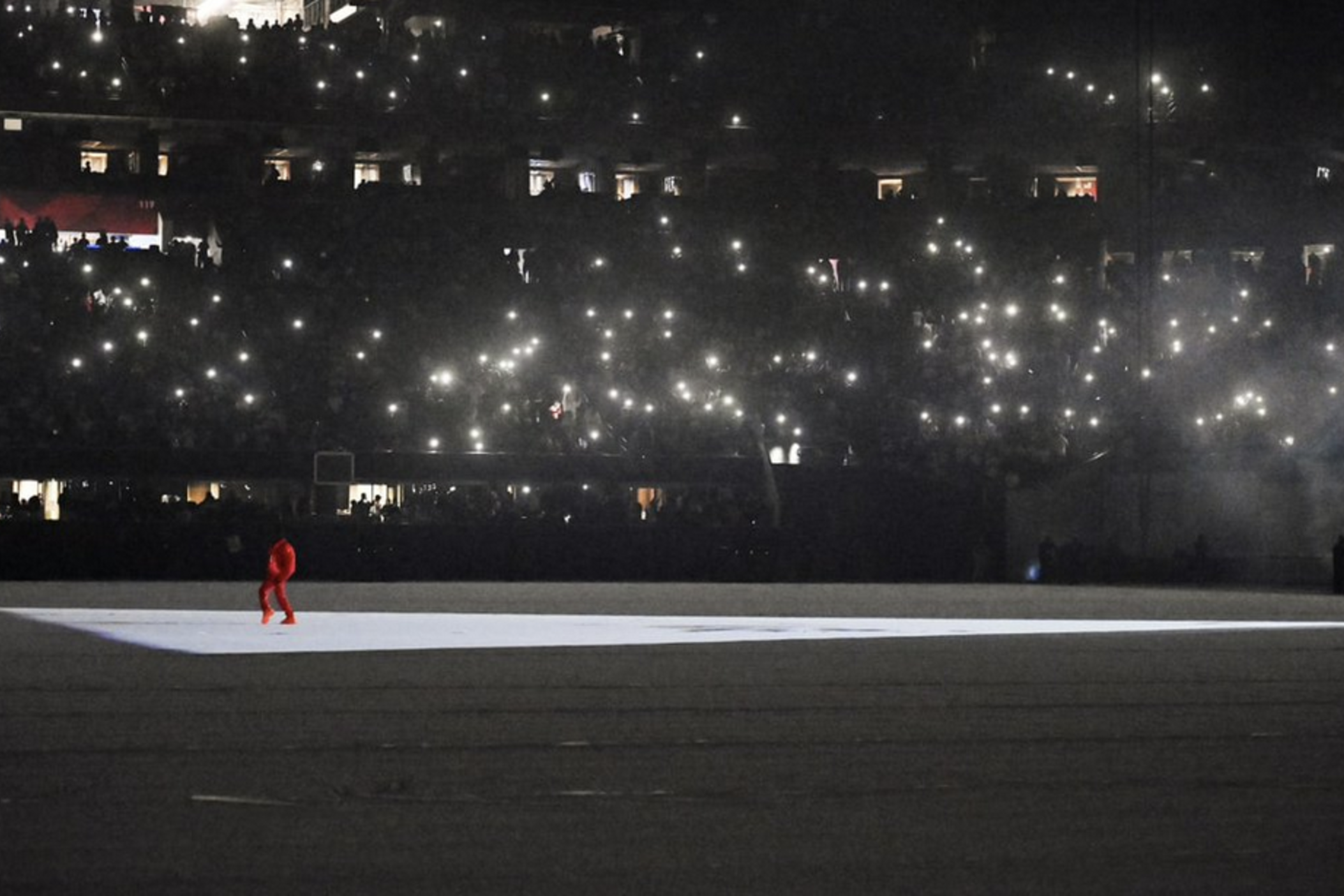 Hip-hop musician Kanye West is dwarfed by a sold-out Mercedes-Benz Stadium in Atlanta during one of two August 2021 listening party events for his upcoming album "Donda."  