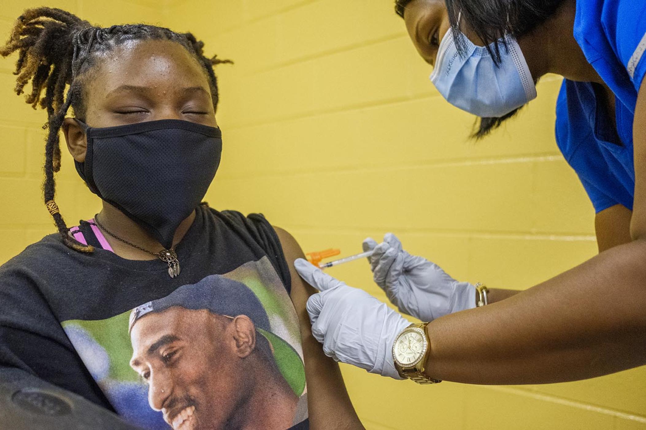 Bibb County middle school student Sade Veal gets her first dose of the Pfizer COVID vaccine at a back to school event sponsored by Bibb County Schools.