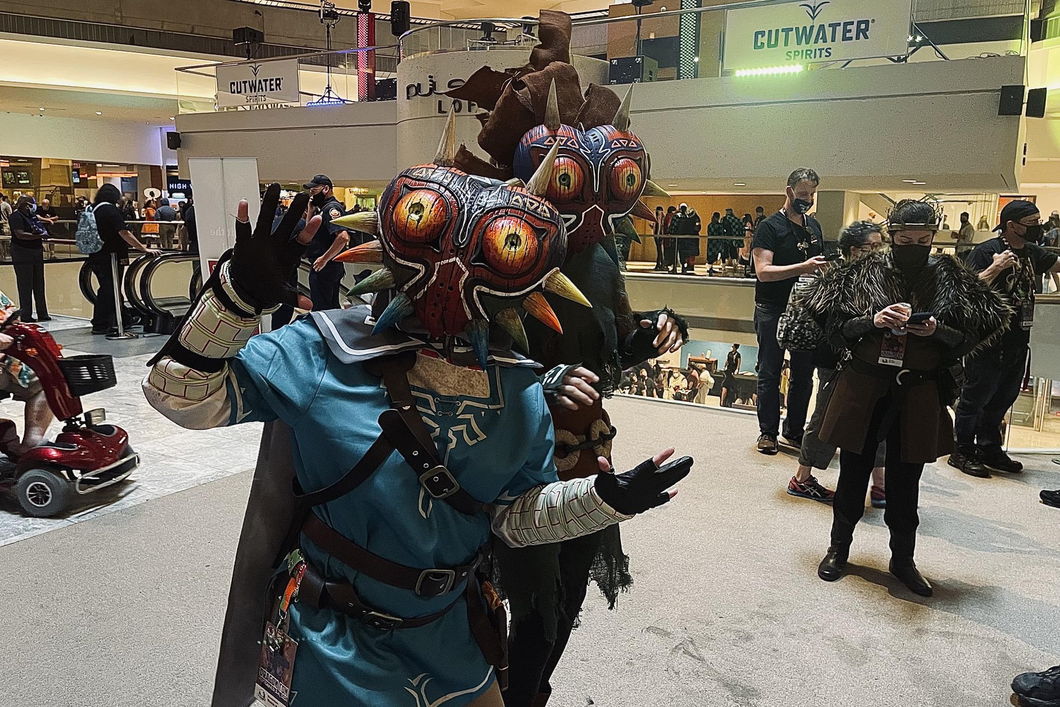 Two cosplayers pose at the Marriott Marquis at Dragon Con 2021. This year's convention was marked by COVID-19 safety precautions and precautions, as well as an attendance cap – due to the surging delta variant across the state. 