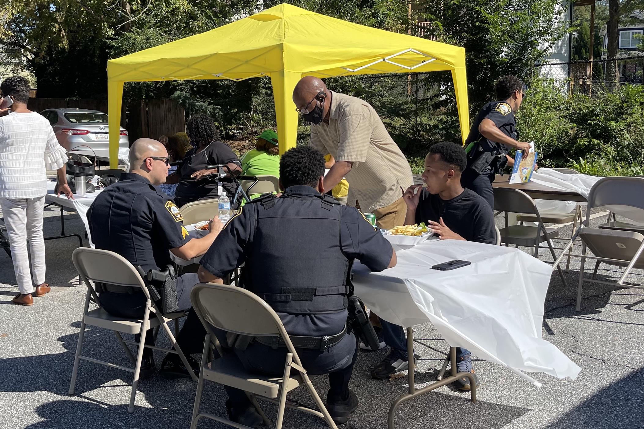 Brookhaven police officers share a meal with members of the community.