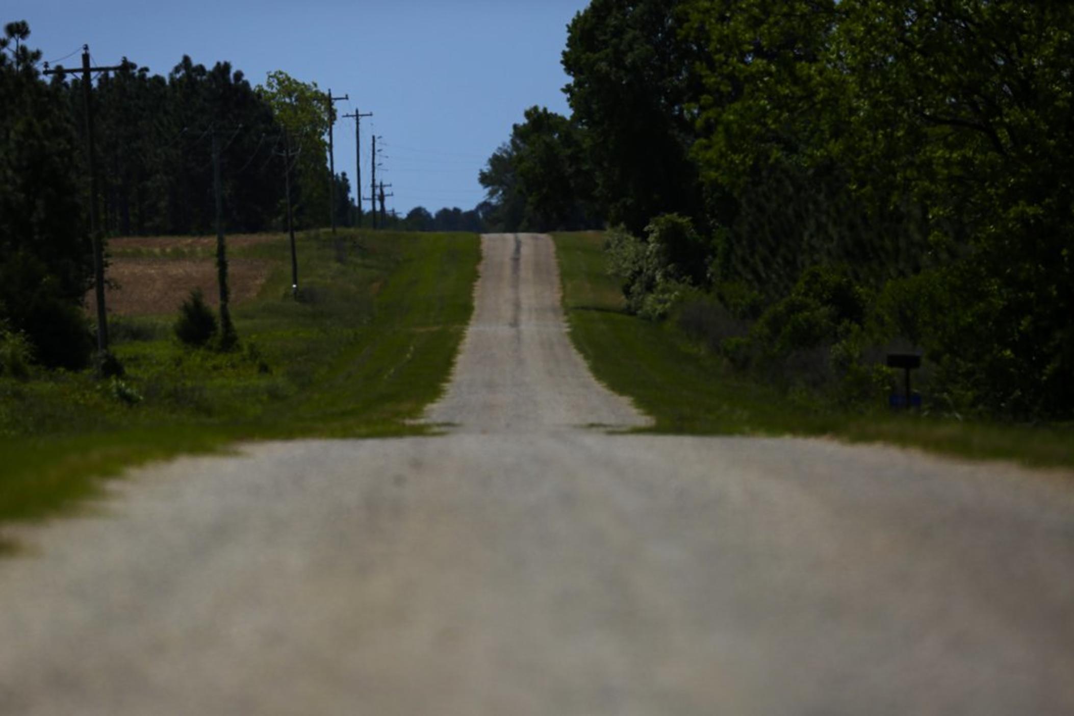 An empty road leading towards a rural countryside of Dawson, Ga.