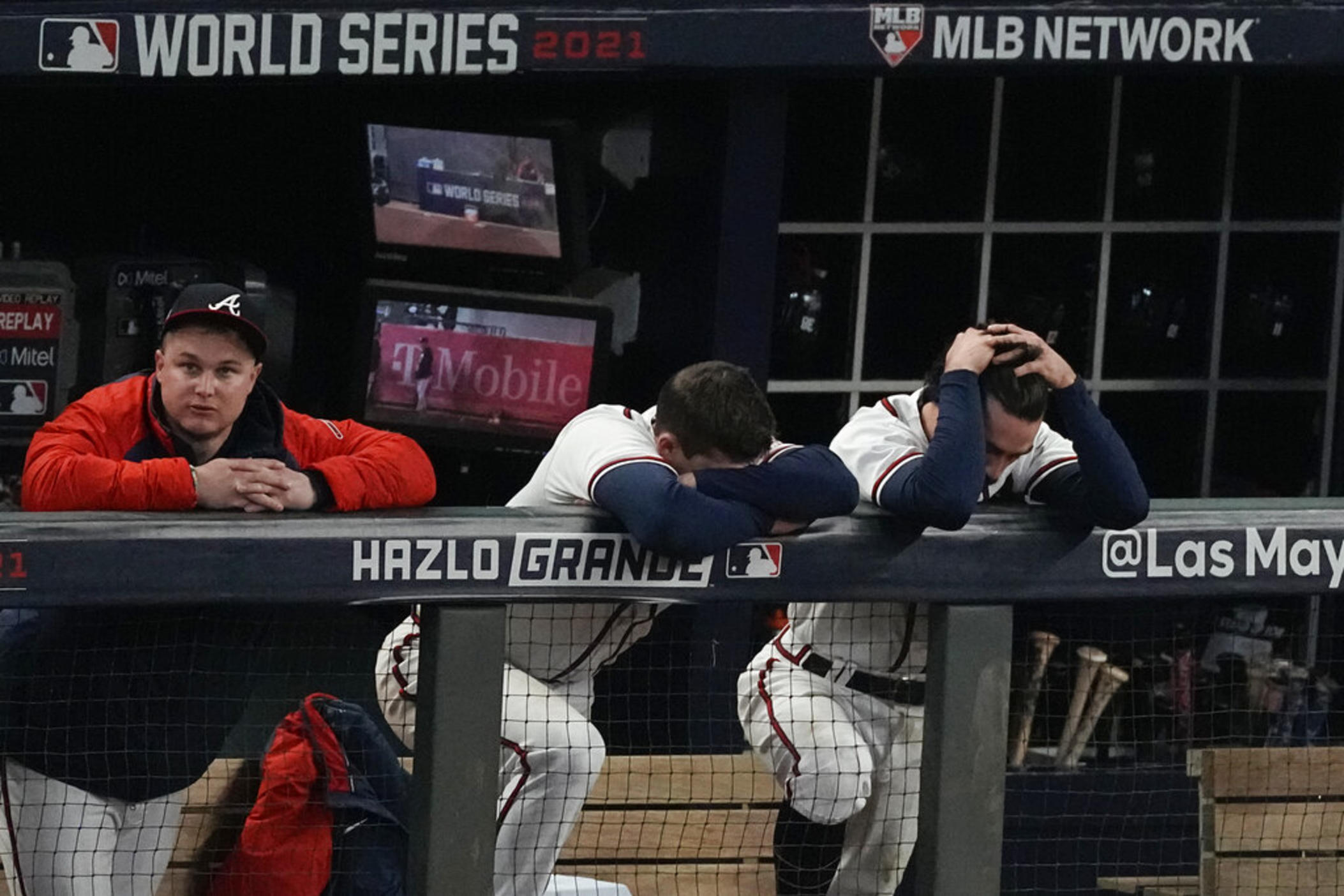 Atlanta Braves right fielder Joc Pederson, from left, third baseman Austin Riley and shortstop Dansby Swanson react during the ninth inning in Game 5 of baseball's World Series between the Houston Astros and the Atlanta Braves Monday, Nov. 1, 2021, in Atlanta. 