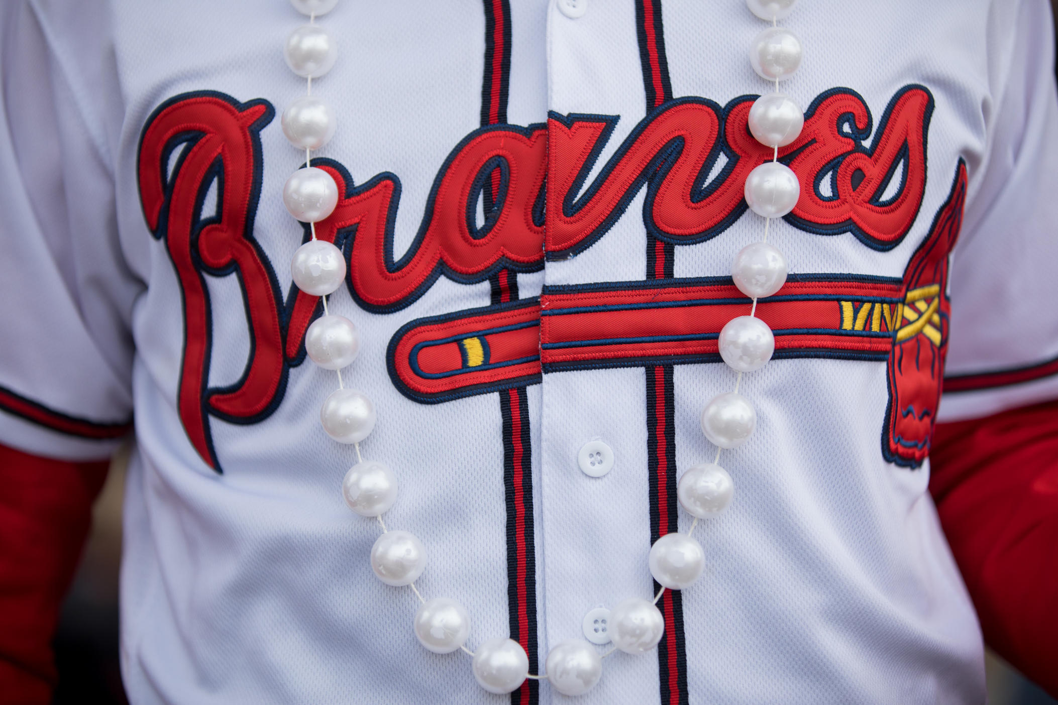 Braves fans don pearls during the celebration at Truist Park on Nov. 5 in honor of Braves outfielder Joc Pederson.