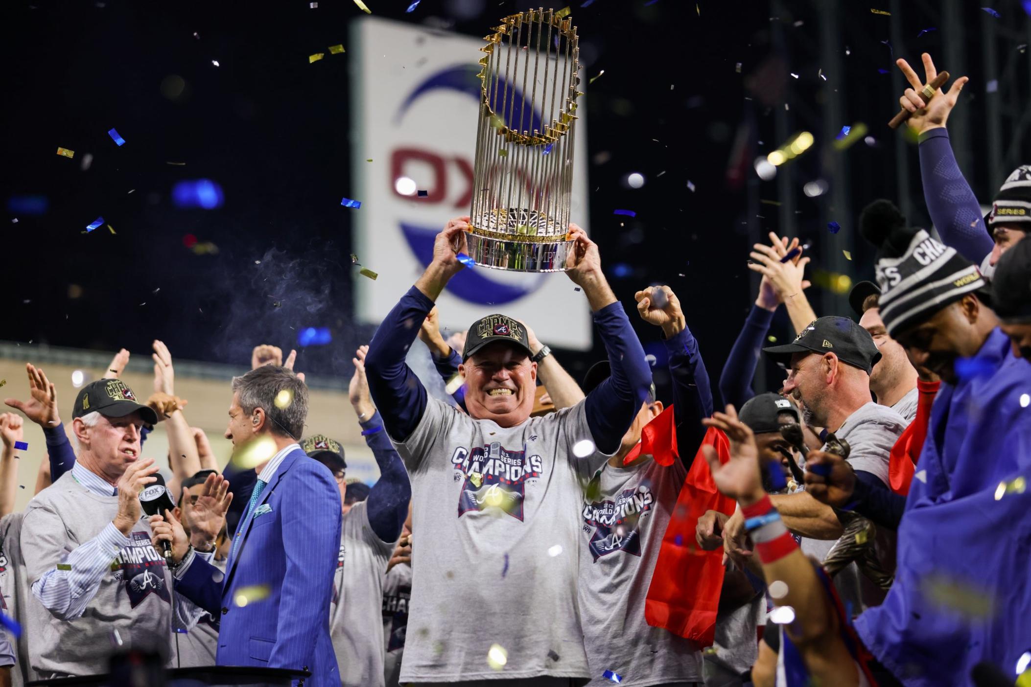 Braves manager Brian Snitker holds up the World Series Trophy in celebration, joining his mentor Bobby Cox as the only Atlanta Braves managers to win the World Series.
