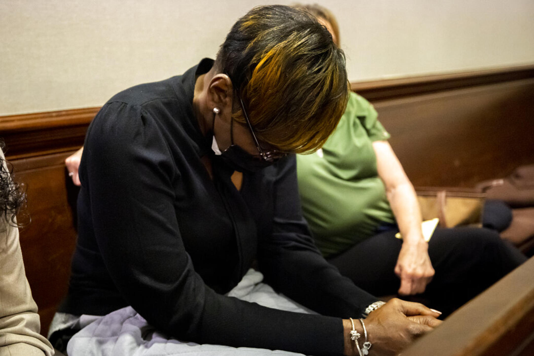 Ahmaud Arbery's mother Wanda Cooper-Jones reacts to autopsy photos entered into evidence during the trial of Greg McMichael and his son, Travis McMichael, and a neighbor, William "Roddie" Bryan in the Glynn County Courthouse, Tuesday, Nov. 16, 2021, in Brunswick, Ga.