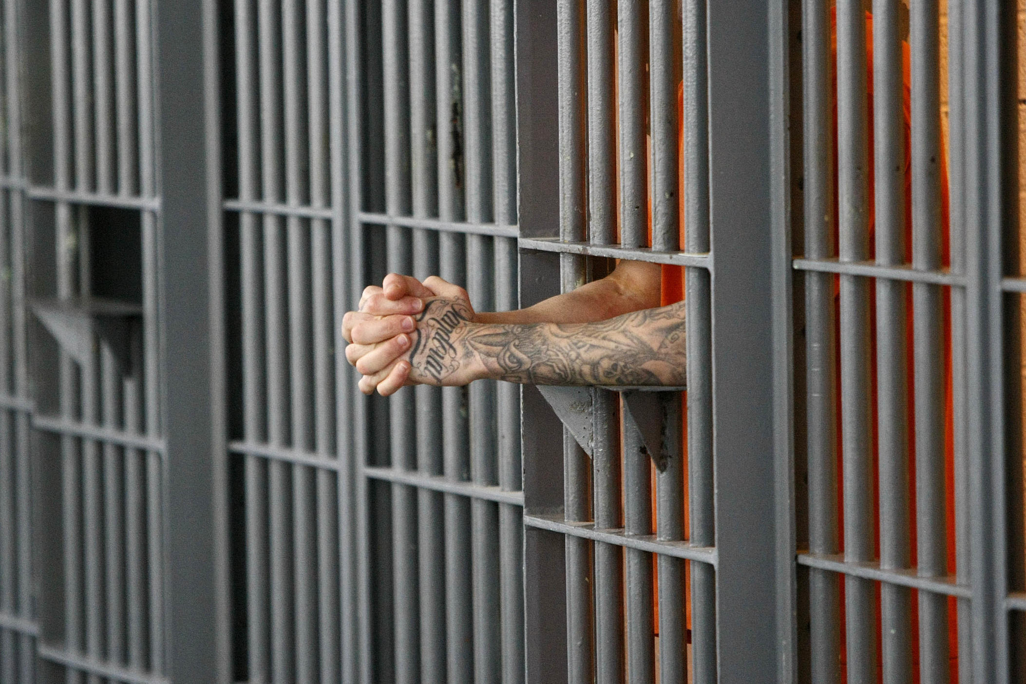 FILE - In this Nov. 14, 2009 file photo, an inmate stands at his cell door at the maximum security facility at the Arizona State Prison in Florence, Ariz. A new Arizona law that charges visitors to state prisons a one-time $25 fee is being challenged as unconstitutional.